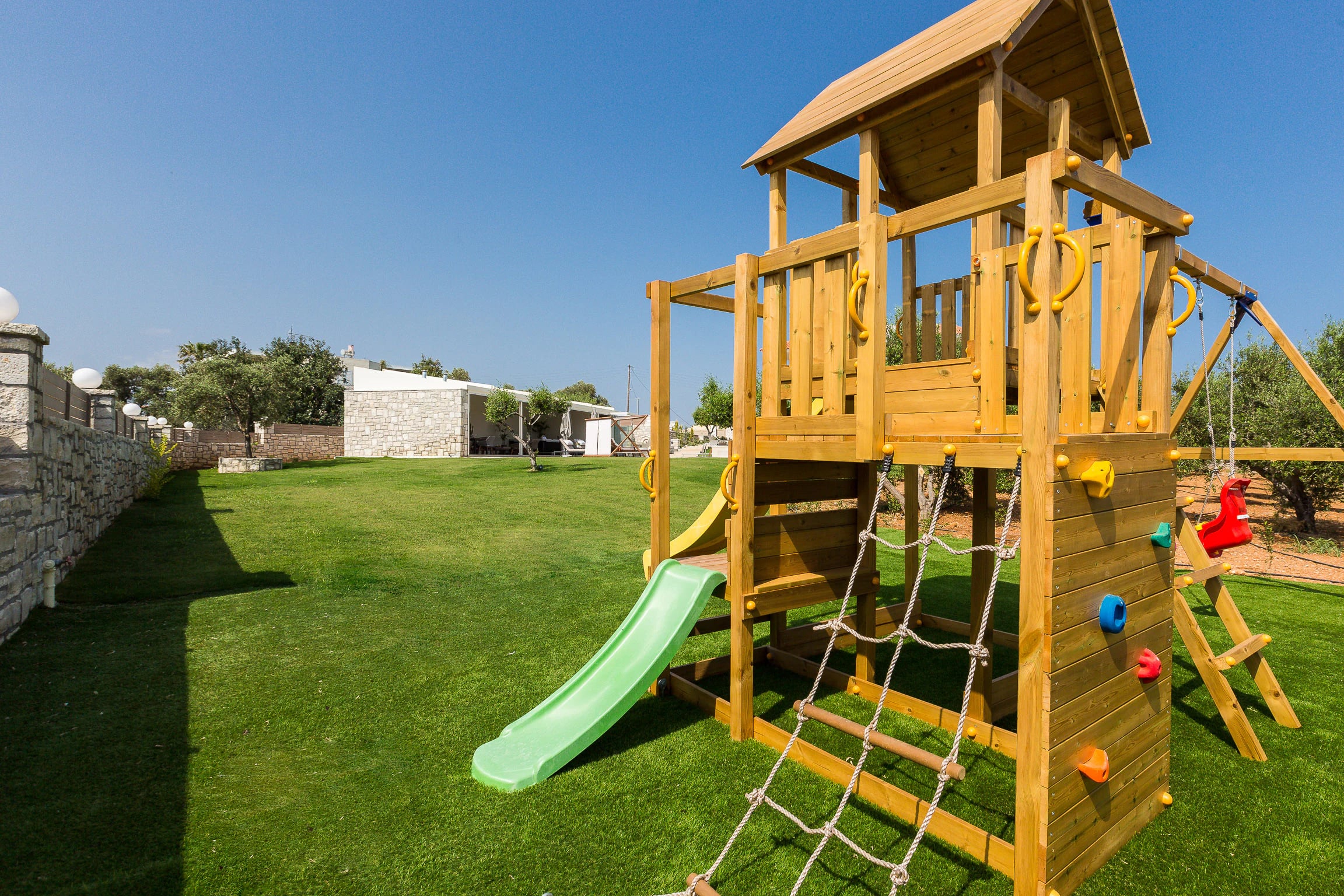Children's wooden playground on the private lawn