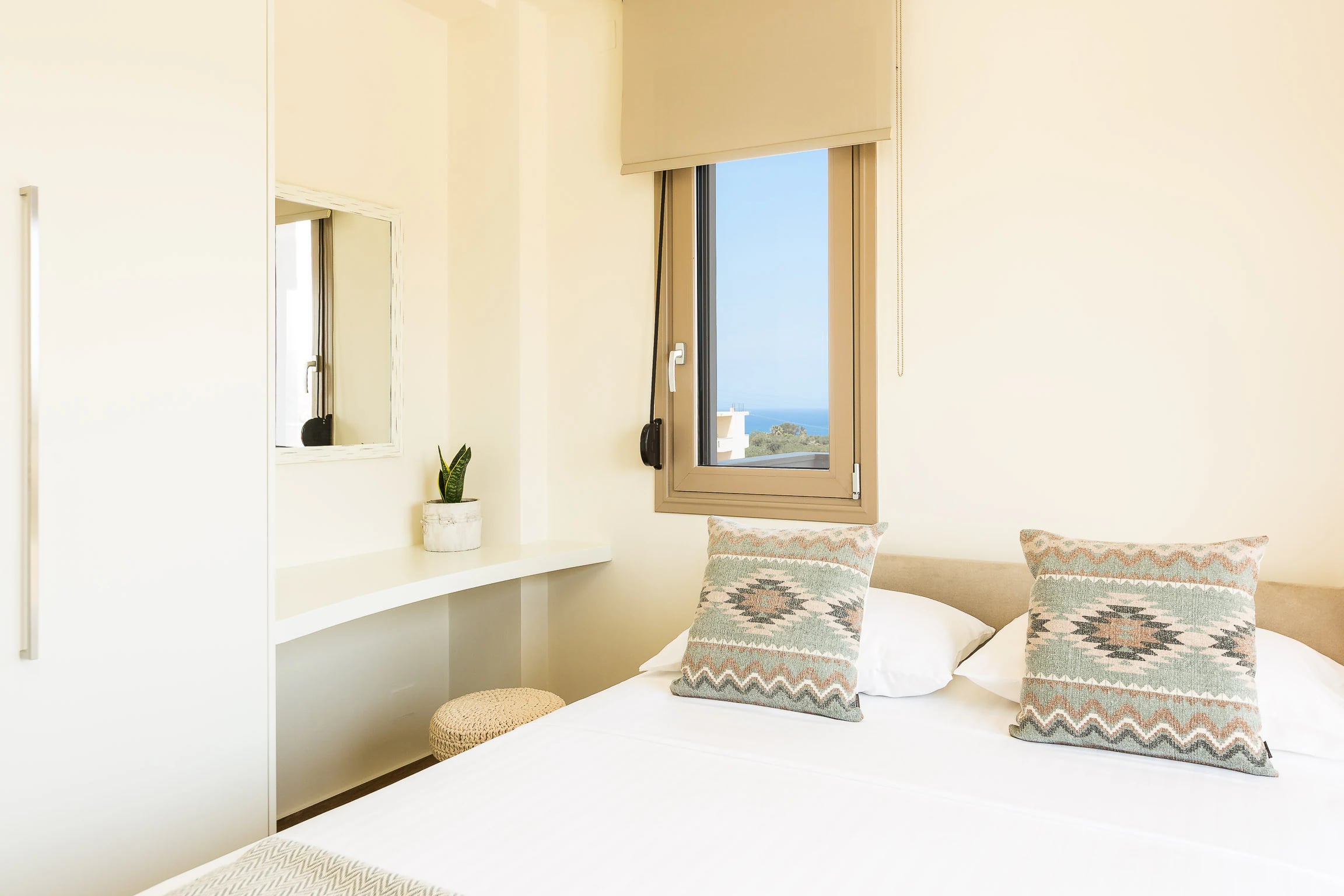 Bright bedroom with a double bed and soft neutral finishes